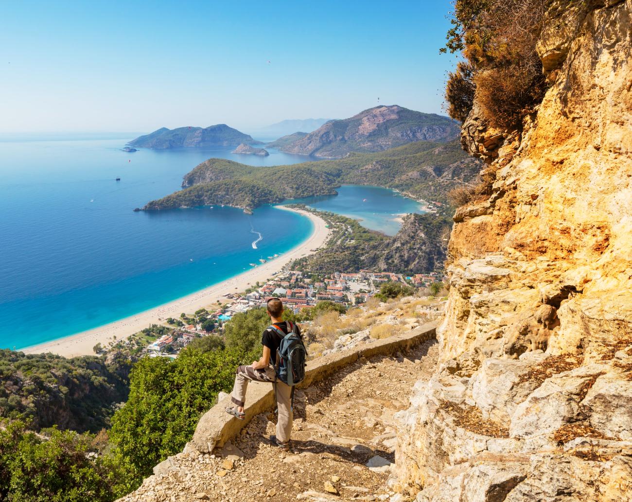 Hiker overlooking seascape, on the Lycian Way trail in Turkey